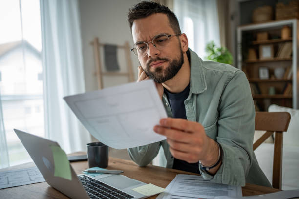 istock Man working remotely in his home office, fully engaged 2196935661