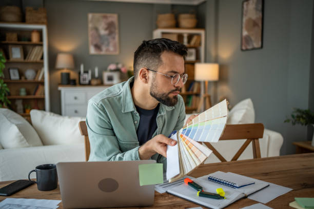 istock Designer selecting colors from a palette in a creative home office 2196935787