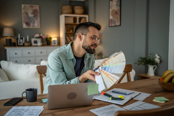 istock Designer selecting colors from a palette in a creative home office 2196935819