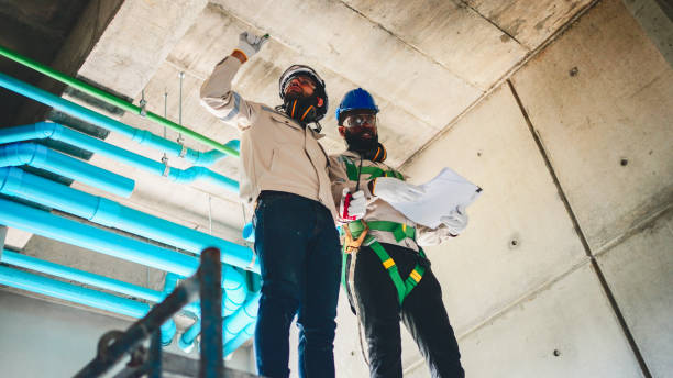 istock Male builder measuring plastic pipes with new home construction. 2196936284