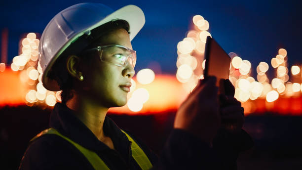 istock Female engineer using digital tablet for work at electrical power plant at night time. 2196936542