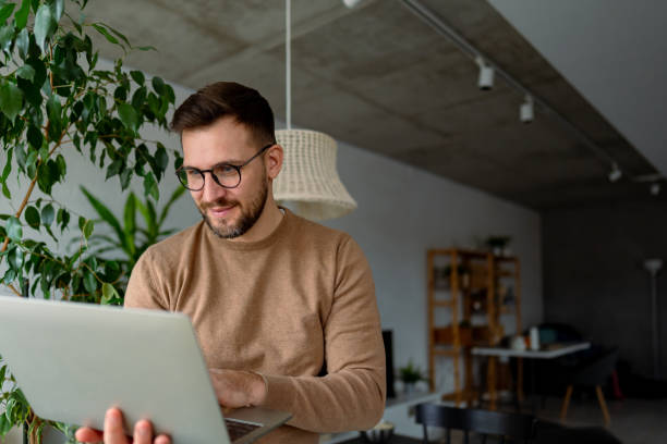 istock Young businessman working from home typing on his laptop 2196936936
