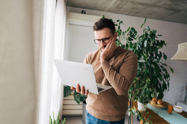 istock Stressed businessman having toothache while working from home 2196936972