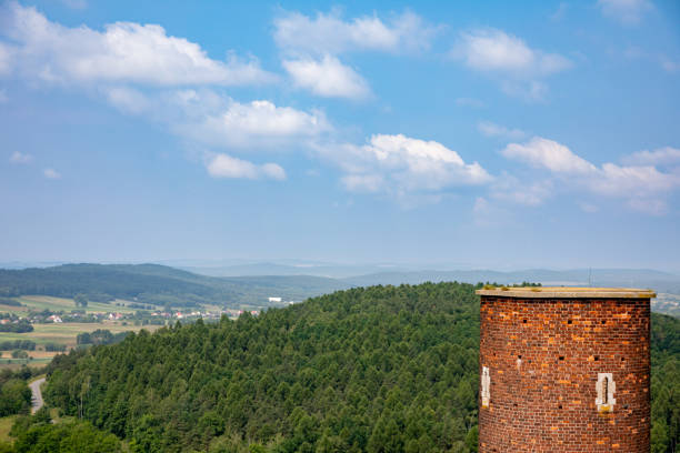 This breathtaking landscape showcases a stunning hill, a charming tower, and an exceptionally picturesque sky
