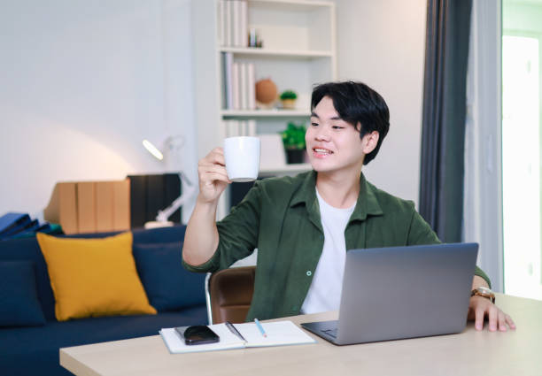 istock Freelance Lifestyle A man is focusing on drinking coffee before starting work. 2196938104