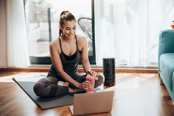 istock Woman Doing Online Workout At Home 2196938175