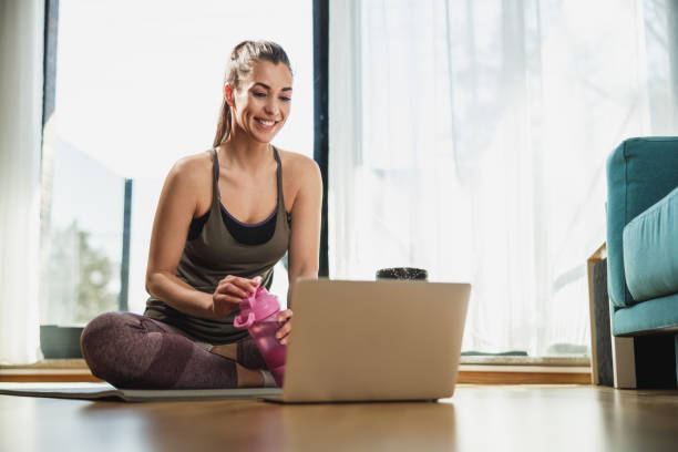 istock Woman Doing Online Workout At Home 2196938194