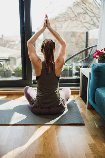istock Woman Practicing A Yoga Routine At Home 2196938754