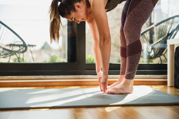istock Woman Practicing A Stretching Yoga Exercises At Home 2196938954