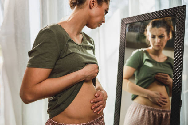 istock Woman Suffering From Stomach Cramps 2196939467