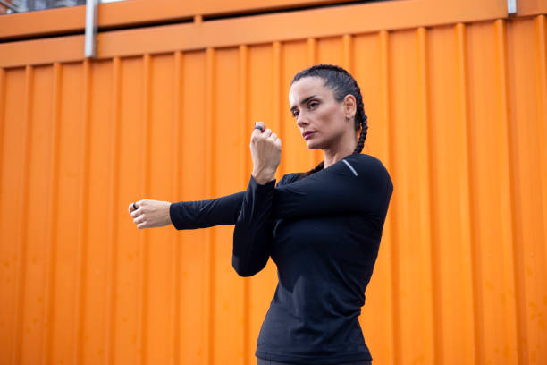 istock Sportswoman stretching arms before running in urban environment 2196939984