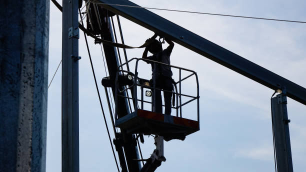 istock Man workers  on a crane performs high-rise work on welding metal structures of new tower at height.Silhouette Photo 2196940246