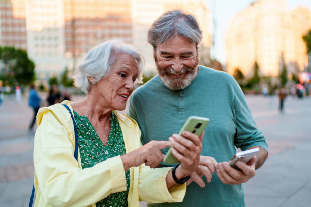 istock Senior couple using smartphone in a city square 2196943443