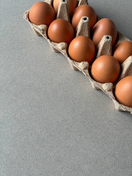 istock Brown chicken eggs in a paper tray top view 2196943486