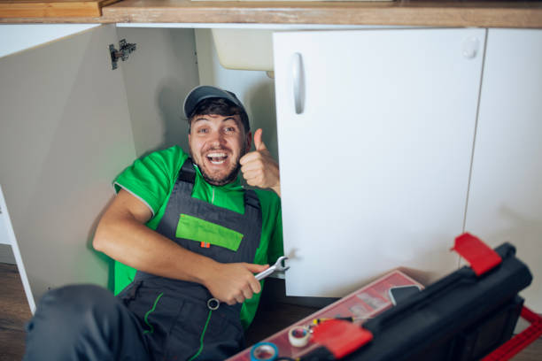 istock Portrait of a professional plumber in work attire fixing a kitchen pipe. 2196943741