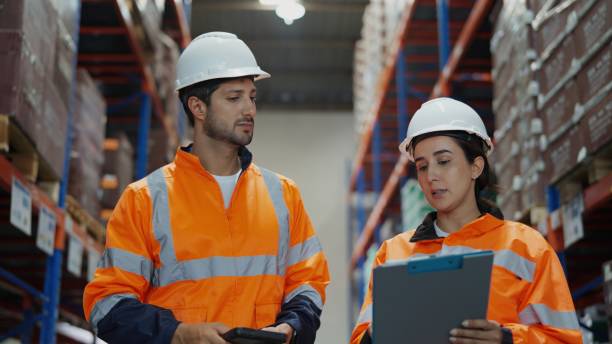 istock Discussion among warehouse staff over digital tablets reflects professional collaboration in a manufacturing setting. 2196946406