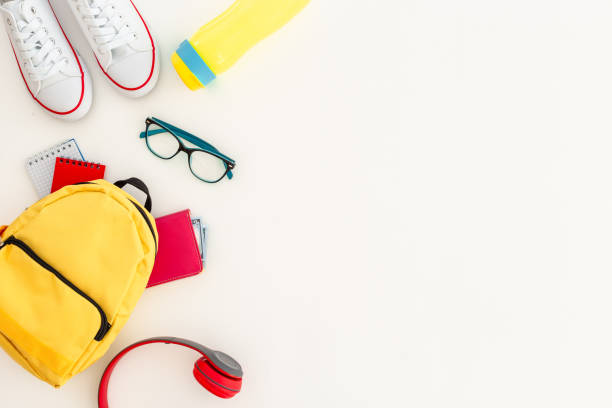 istock Student school yellow backpack with supplies, top view. Flatlay 2196946725