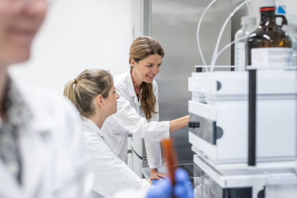 istock Female pharmacists at work with a device for high-resolution liquid chromatography. 2196950227