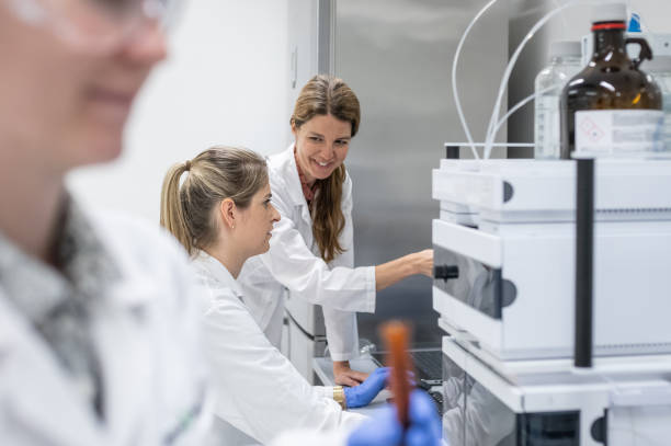 istock Female pharmacists at work with a device for high-resolution liquid chromatography. 2196950238