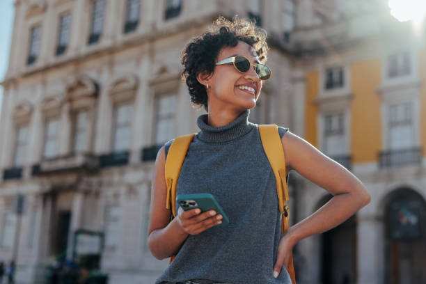 istock Tourist with backpack and smart phone exploring a european city 2196950548