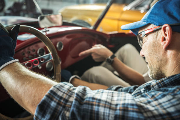 A Car Enthusiast Inspects Dashboard Components While Working on a Vintage Car in a Garage