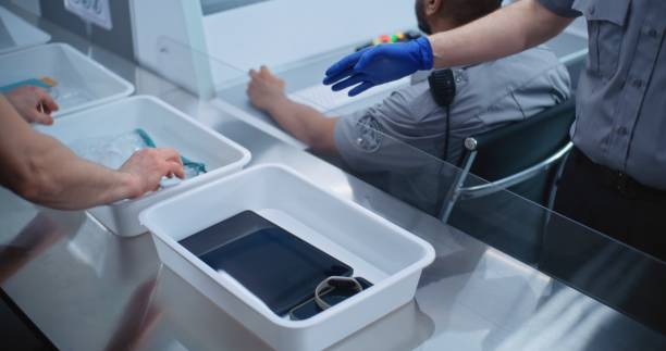 istock Boarding Flight: Diverse Passengers Put Personal Belongings in Plastic Trays for Screening 2196955135
