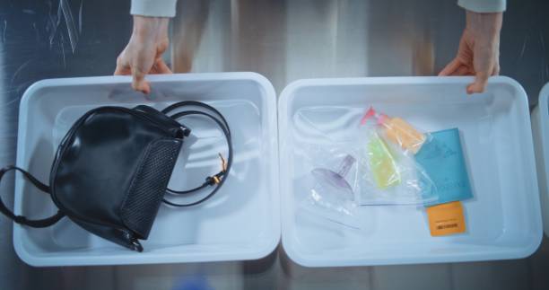istock Top View on Passengers Placing Personal Items in Plastic Tray for Screening. Airport Security Checkpoint 2196955960