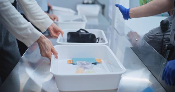 istock Diverse People Put Personal Items in Plastic Trays for Screening. Security Officers Control Procedures 2196957434
