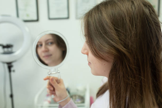 istock woman is looking at herself in a mirror. 2196957674