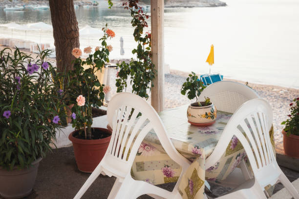 istock Empty table and plastic chairs in the early morning - Charaki, Greece 2196957736