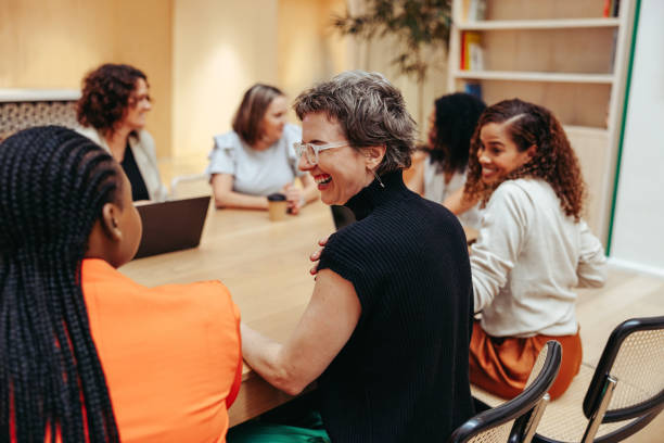 istock Multicultural employees smiling and interacting during a casual meeting 2196957951