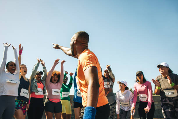 istock Excited runners gather at marathon starting line on sunny day 2196958714