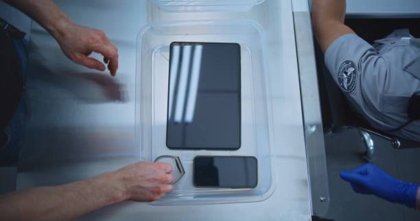 istock Top View on Passengers Placing Personal Items in Plastic Tray for Screening before Boarding Flight 2196958770