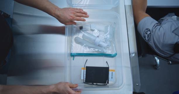 istock Top View on Passengers Placing Personal Items in Plastic Tray for Screening before Boarding Flight 2196958974