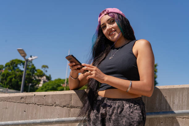 istock A smiling young millennial woman checking her cell phone messages 2196960807