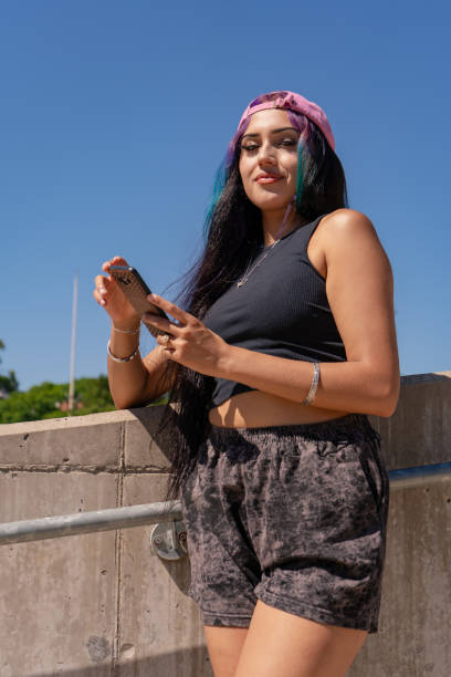 istock A smiling young millennial woman checking her cell phone messages 2196960815