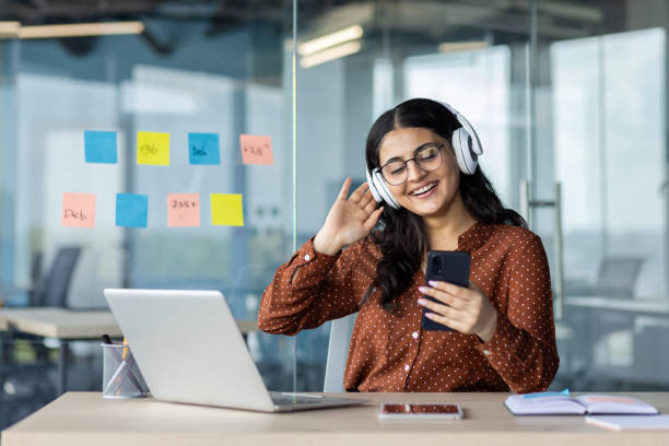 istock Woman Enjoying Music While Working in a Modern Office Environment 2196963470