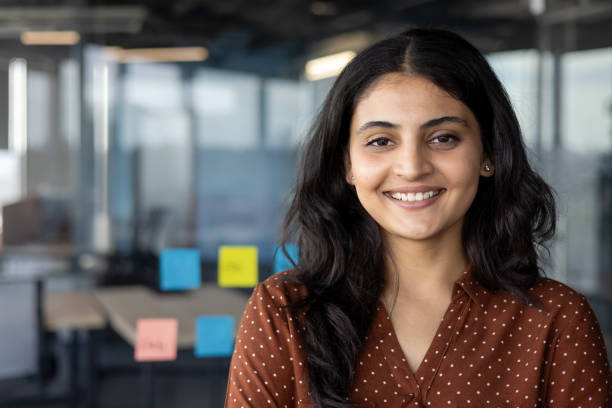 istock Confident young businesswoman smiling in modern office environment 2196963537