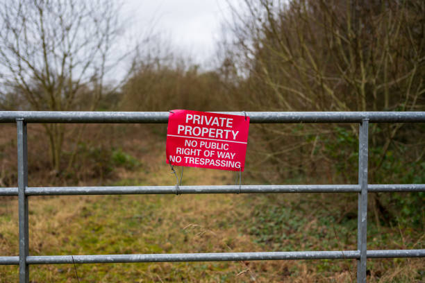 istock Private property sign on a gate blocking access to a rural path. 2196964025