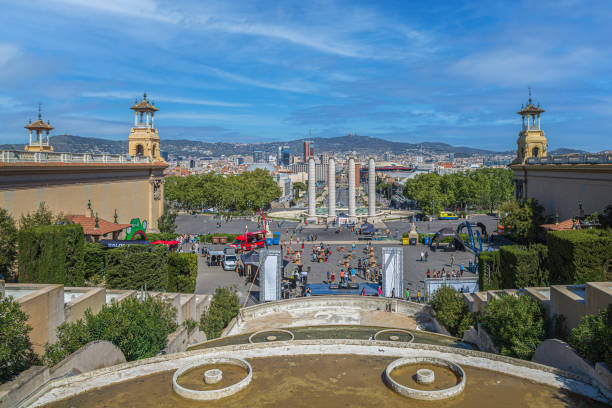 Barcelona: Perspective view from Fuentes de Montjuic to Four Columns (Les Quatre Columnes), Senyera Catalana sculpture, Fuentes de Montjuic, Torres Venecianes, Plaça d'Espanya.