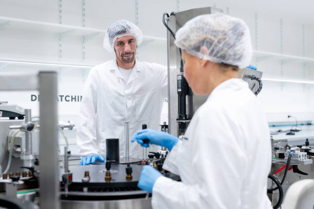istock Pharmaceutical workers on the production line for filling and packing bottles. 2196965040