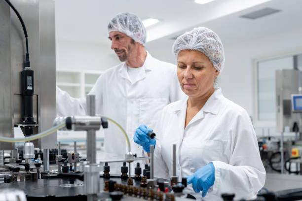 istock Pharmaceutical workers on the production line for filling and packing bottles. 2196965047