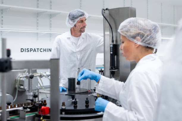 istock Pharmaceutical workers on the production line for filling and packing bottles. 2196965048