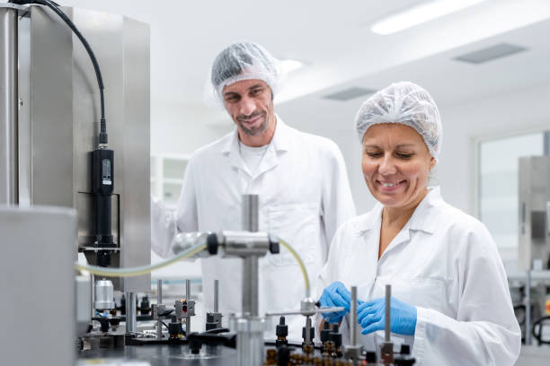 istock Pharmaceutical workers on the production line for filling and packing bottles. 2196965049