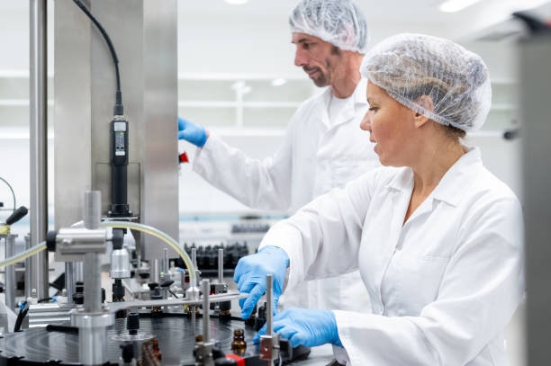 istock Pharmaceutical workers on the production line for filling and packing bottles. 2196965051