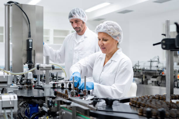 istock Pharmaceutical workers on the production line for filling and packing bottles. 2196965055