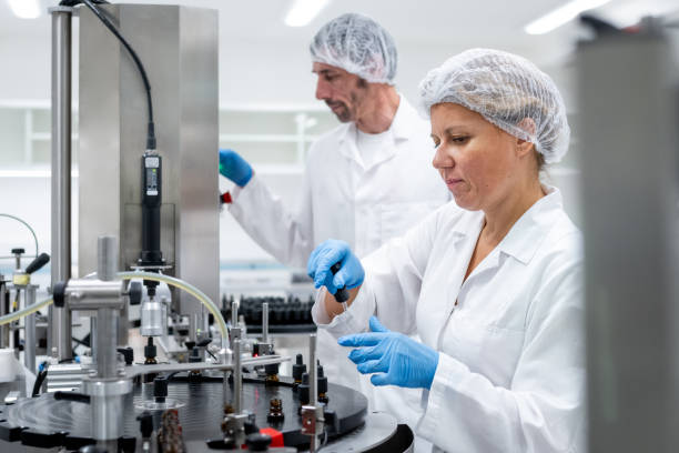 istock Pharmaceutical workers on the production line for filling and packing bottles. 2196965057