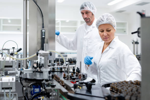 istock Pharmaceutical workers on the production line for filling and packing bottles. 2196965063