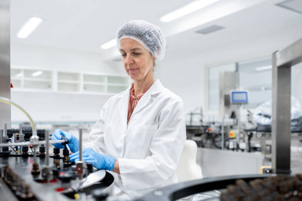 istock Pharmaceutical workers on the production line for filling and packing bottles. 2196965104
