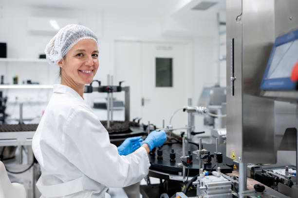 istock Pharmaceutical workers on the production line for filling and packing bottles. 2196965170